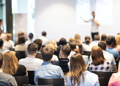 Audience listening to a speaker presentation