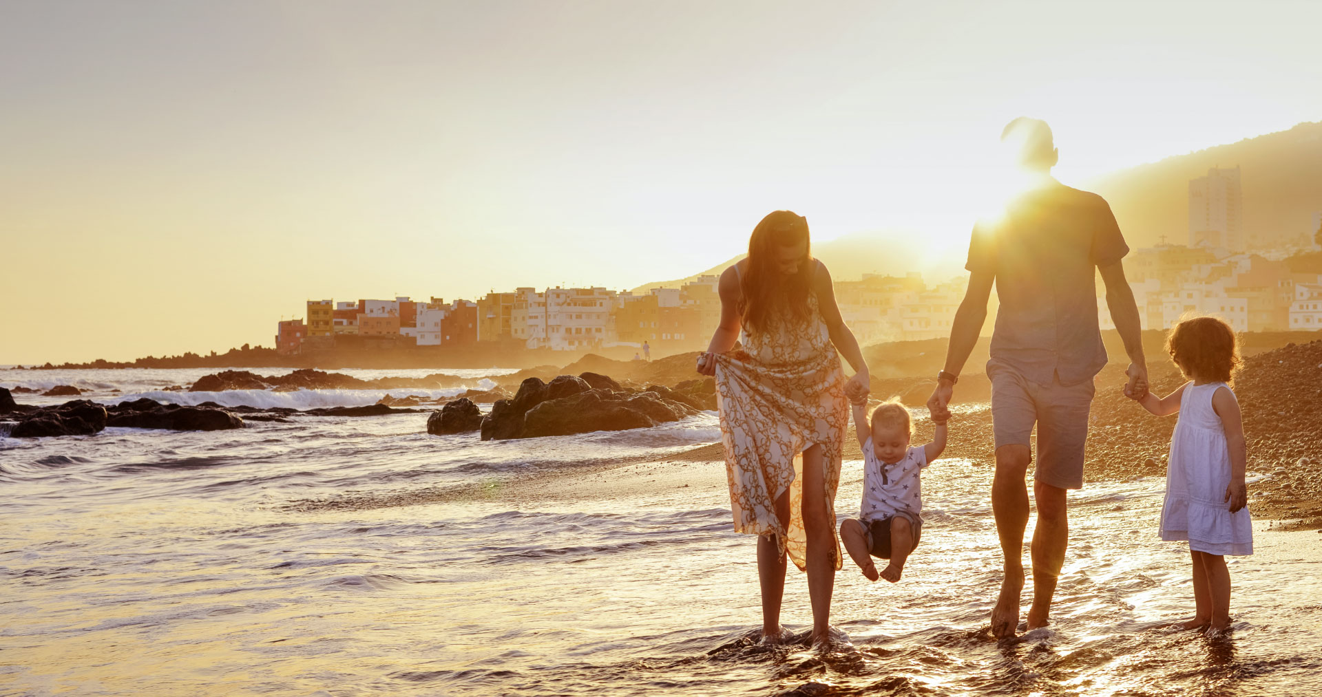 Family with children walking on the beach